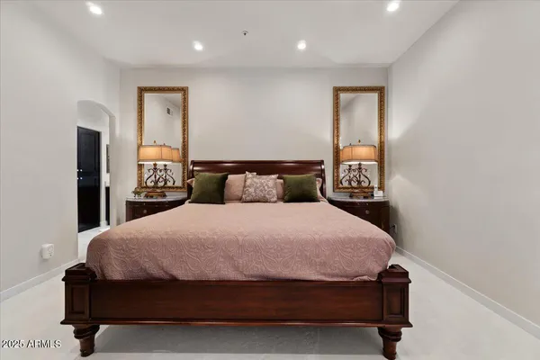 a bedroom with a bed and a night stand