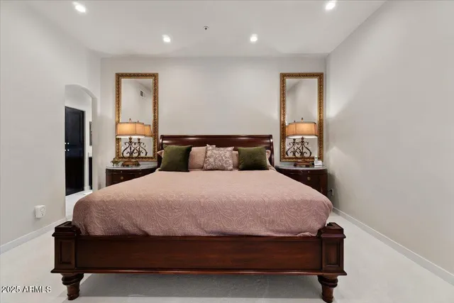 a bedroom with a bed and a night stand