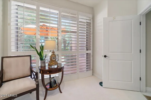 a view of a room with furniture and a window