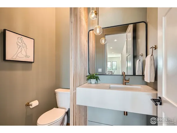 a bathroom with a sink mirror vanity and toilet