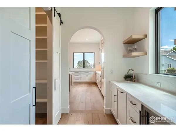 a kitchen with a sink and a large mirror