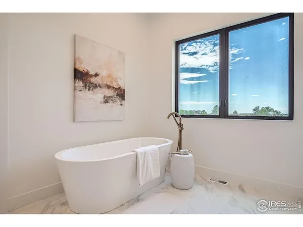 a white bath tub sitting next to a white sink