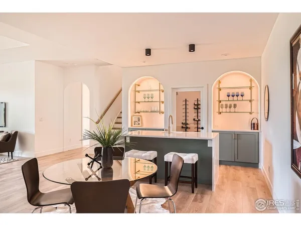 a dining room with furniture and a large window