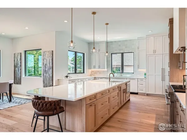 a large kitchen with kitchen island a large island in the center