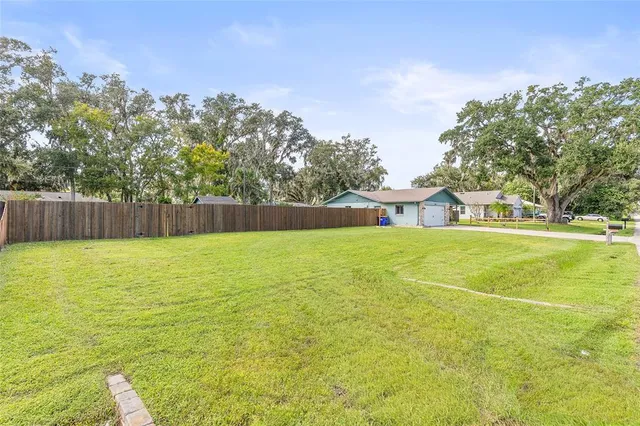a view of outdoor space with garden and trees