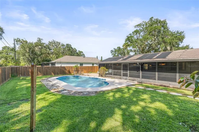 a view of an house with backyard space and balcony