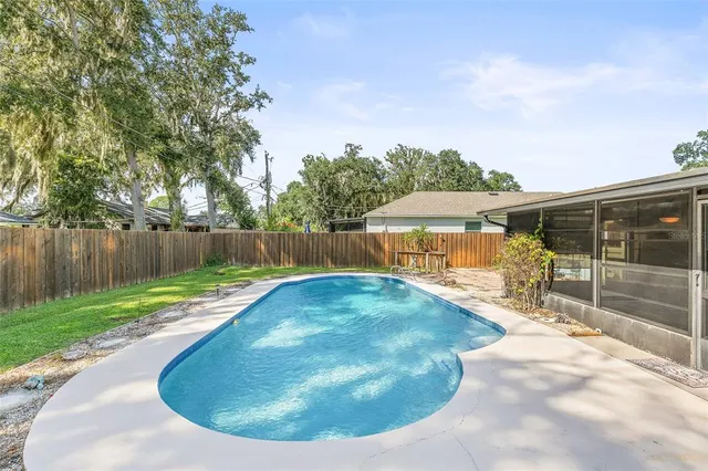 a view of a backyard with swimming pool