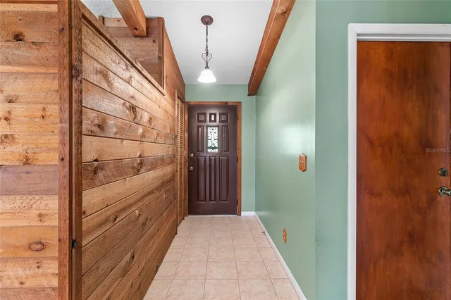 a view of kitchen with refrigerator and cabinets