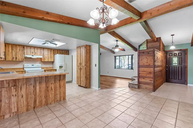a view of an empty room with a fireplace and a window