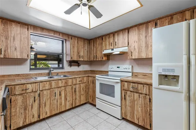 a view of a room with a stylish ceiling fan and bathroom