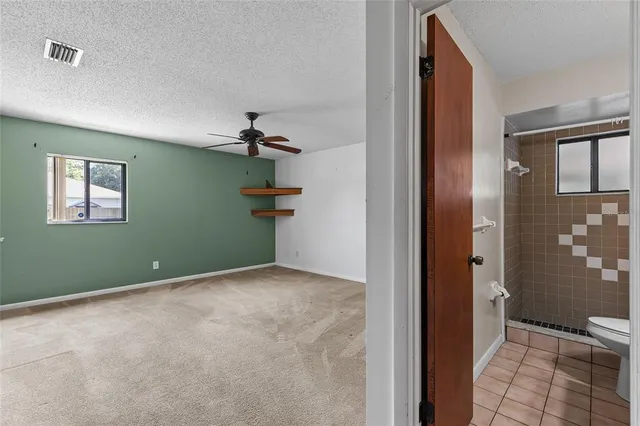 a view of room with a ceiling fan and window