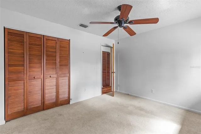 an empty room with windows and closet