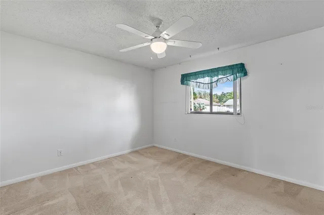 a bathroom with a granite countertop sink a toilet a mirror and bathtub
