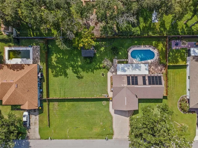 an aerial view of a house with garden space sitting space and swimming pool