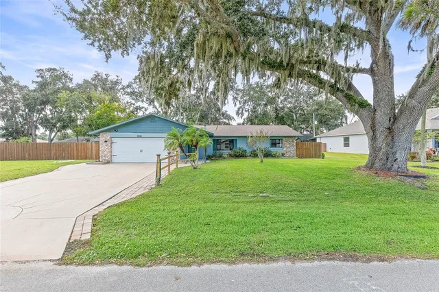 a front view of house with yard and green space