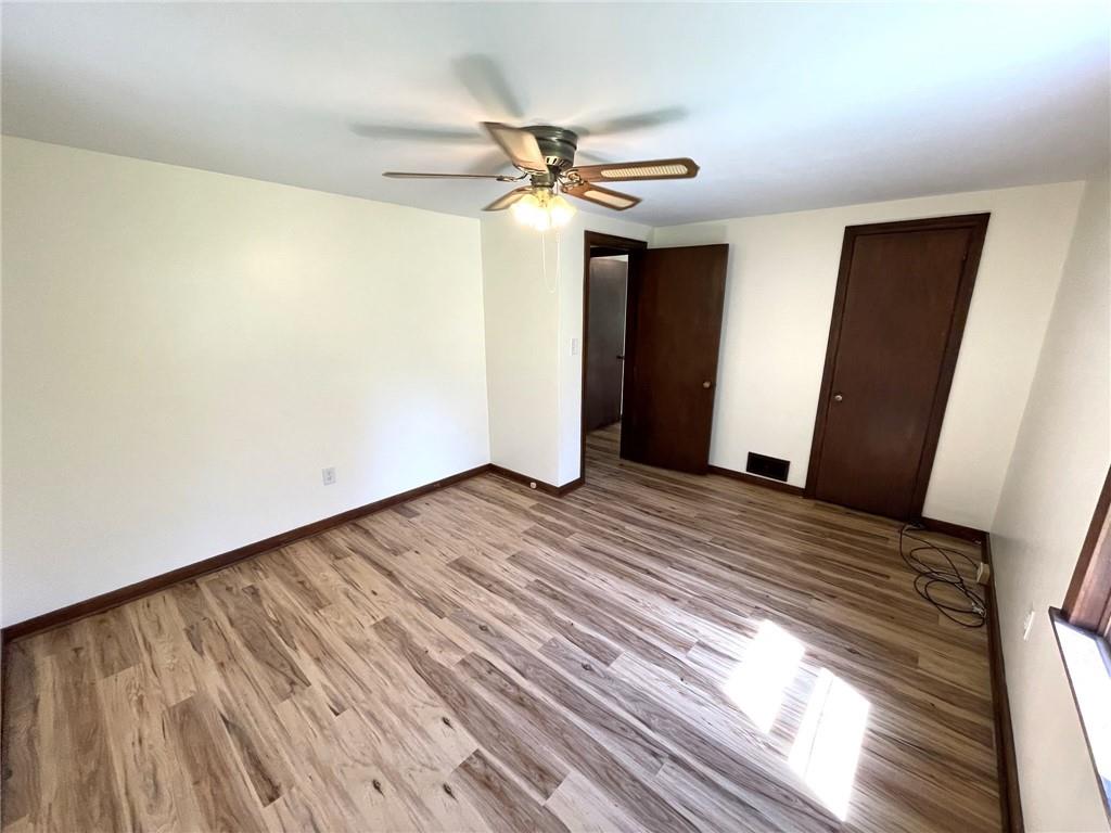 436 East Slippery Rock Road Chicora, PA 16025 - Photo 13 of 40 a view of a livingroom with wooden floor and a ceiling fan