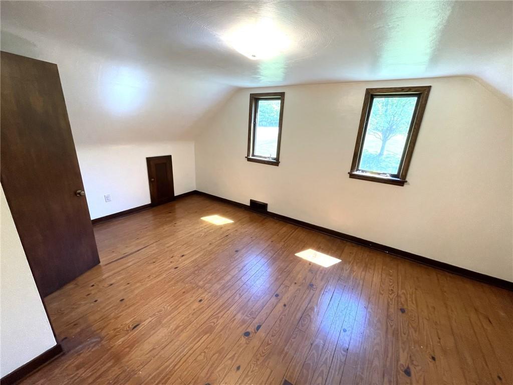 436 East Slippery Rock Road Chicora, PA 16025 - Photo 17 of 40 a view of an empty room with wooden floor and a window