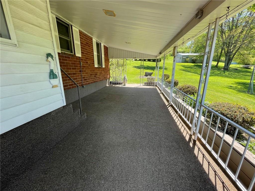 436 East Slippery Rock Road Chicora, PA 16025 - Photo 24 of 40 a view of a porch with wooden floor and stairs