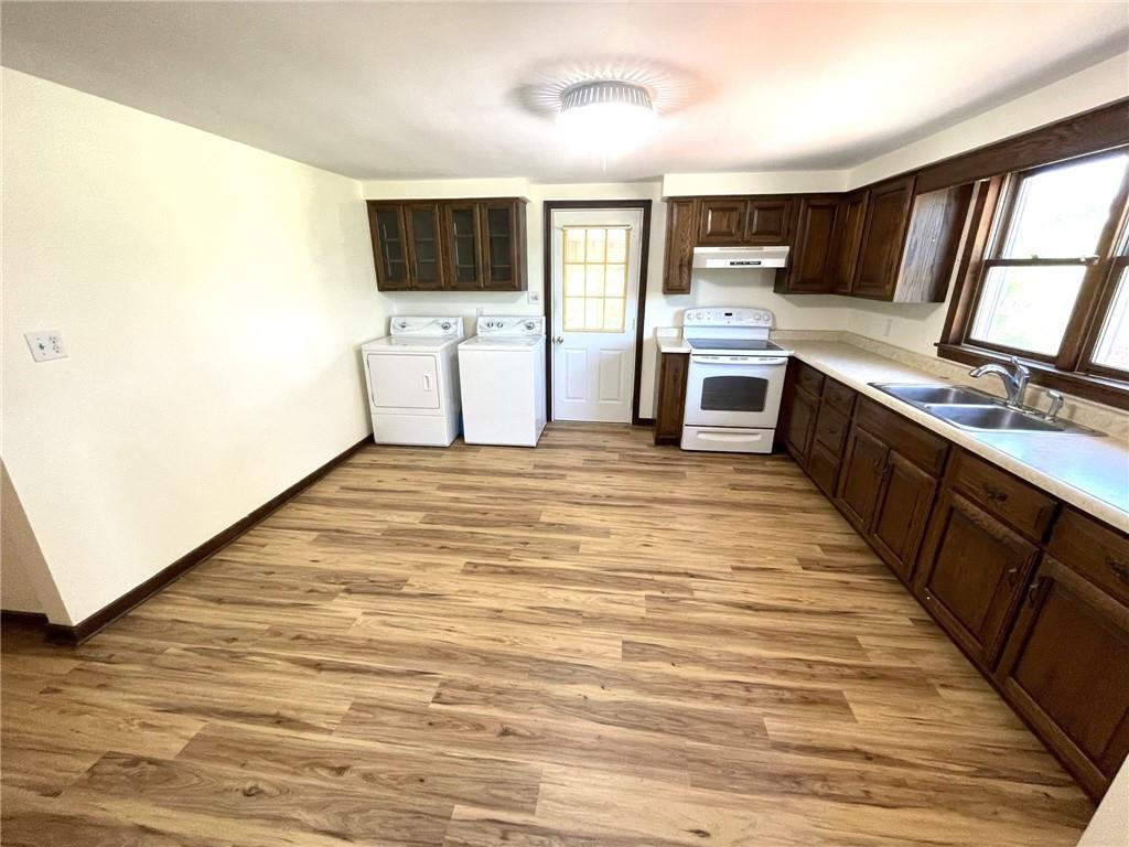 436 East Slippery Rock Road Chicora, PA 16025 - Photo 7 of 40 a large kitchen with stainless steel appliances wooden floor and a sink
