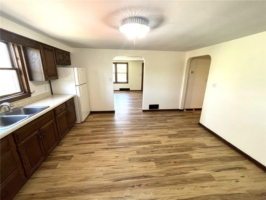 436 East Slippery Rock Road Chicora, PA 16025 - Photo 8 of 40 a view of a kitchen with wooden floor and electronic appliances