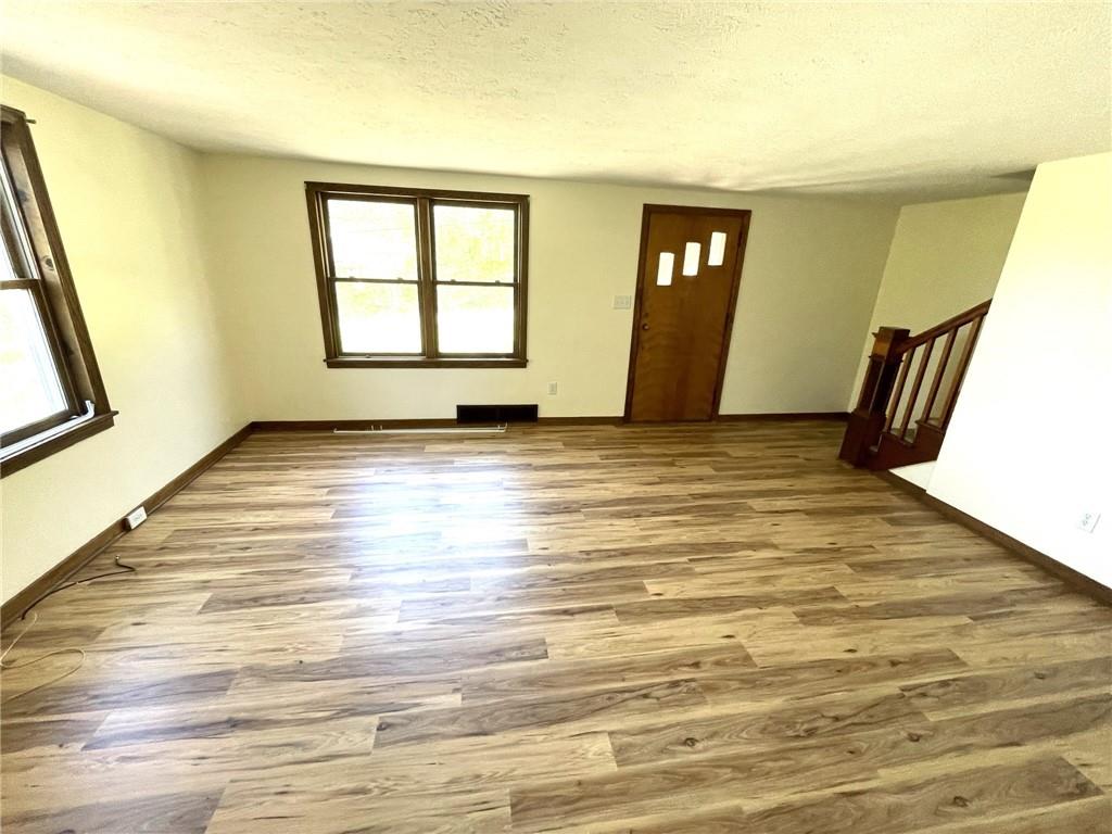 436 East Slippery Rock Road Chicora, PA 16025 - Photo 9 of 40 a view of an empty room with window and wooden floor