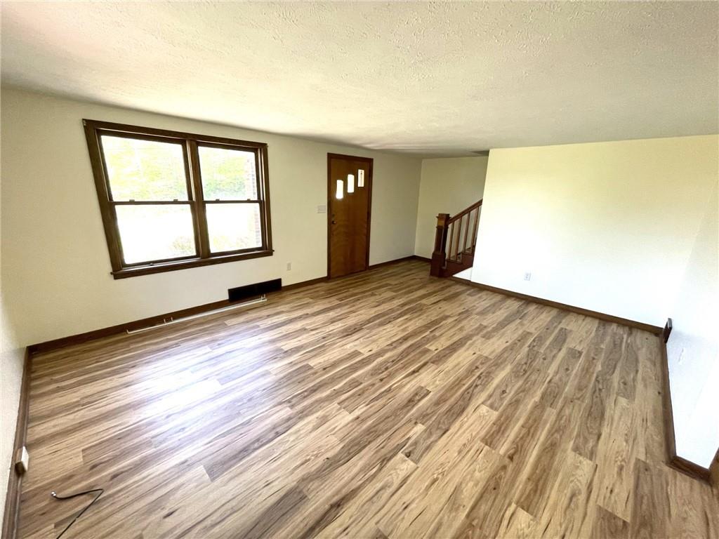 436 East Slippery Rock Road Chicora, PA 16025 - Photo 10 of 40 a view of an empty room with wooden floor and a window