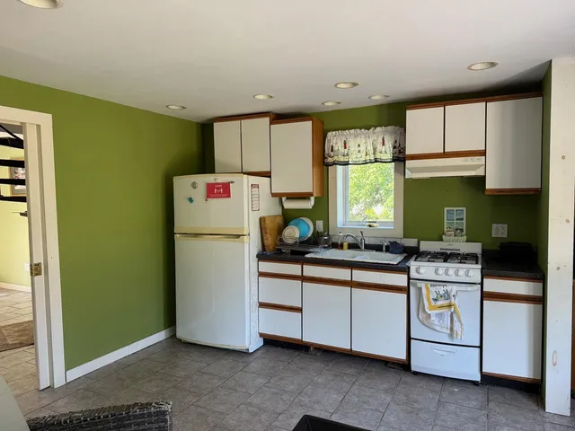 a kitchen with a refrigerator and a sink