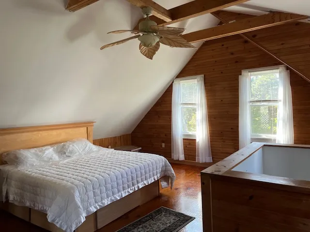 a bedroom with a bed and a window