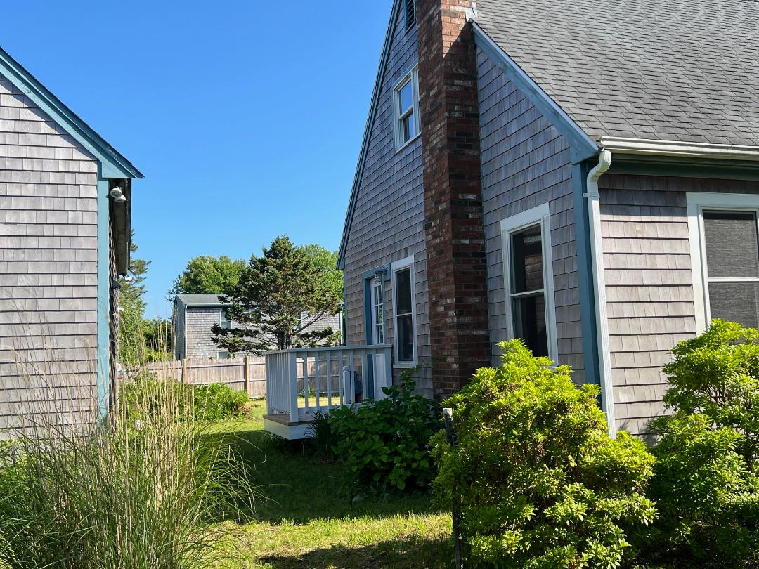 2 Farmers Road Edgartown, MA 02539 - Photo 4 of 27 a backyard of a house with plants and outdoor seating