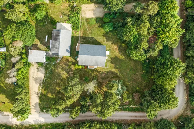 an aerial view of a house with a yard