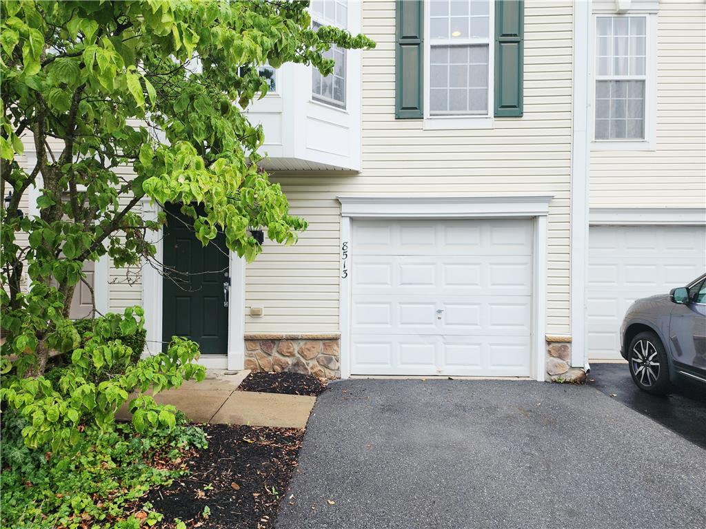 8513 Gateway Road Breinigsville, PA 18031 - Photo 2 of 45 A welcoming facade features a dark entry door and an attached garage with a paved driveway.