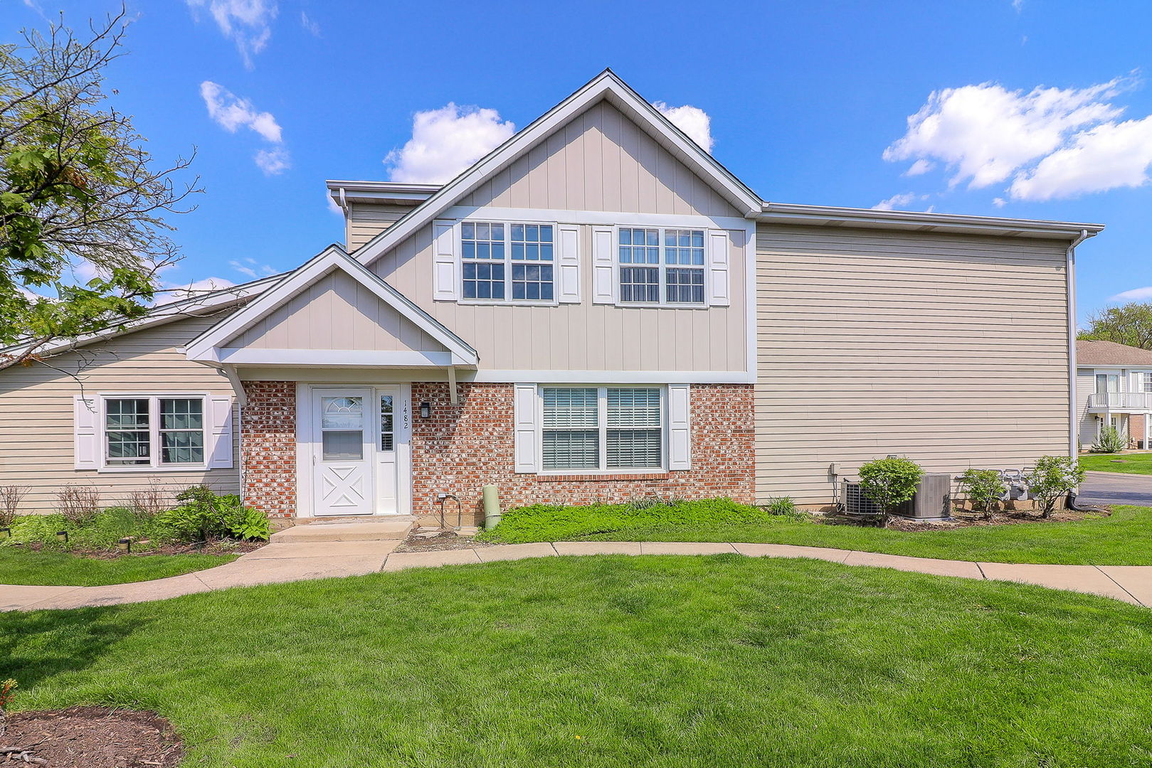 1482 Timber Trail, Unit B Wheaton, IL 60189 - Photo 1 of 20 a front view of a house with a yard and green space