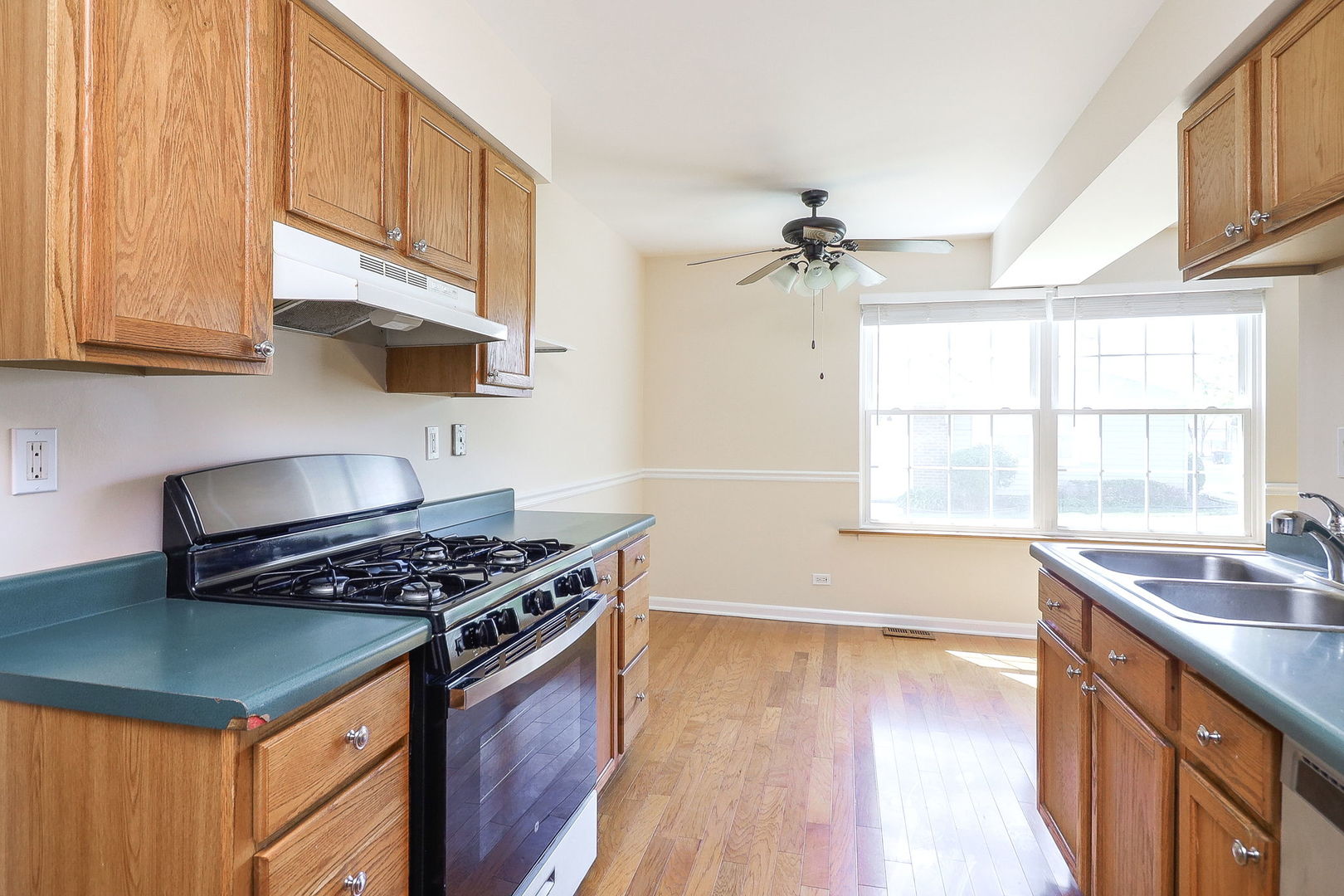 1482 Timber Trail, Unit B Wheaton, IL 60189 - Photo 6 of 20 a kitchen with stainless steel appliances granite countertop a sink a stove and a wooden floors
