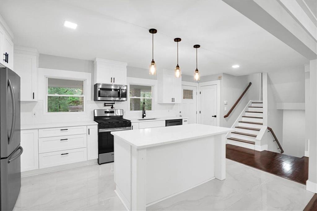 2271 Cresta Drive Decatur, GA 30032 - Photo 11 of 47 a kitchen with white cabinets and appliances