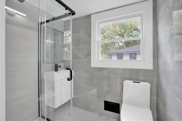 a bathroom with a shower and a toilet