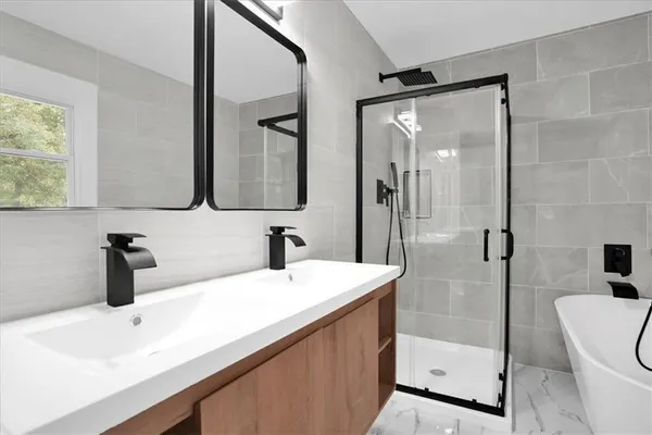 a bathroom with a sink a toilet and shower
