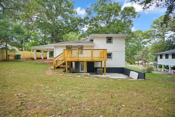 a view of a house with a yard balcony and sitting area