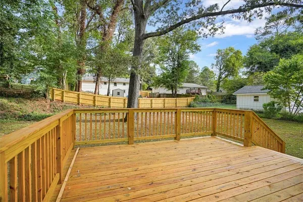 a view of a balcony with wooden floor and fence