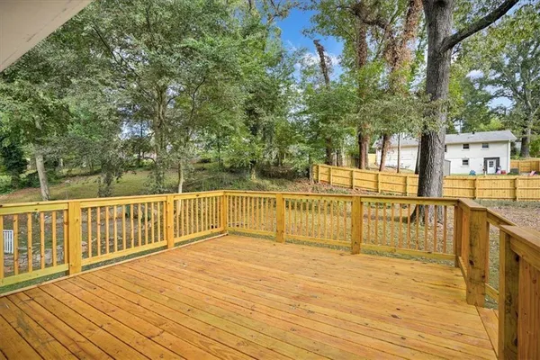 a view of a balcony with wooden floor and fence