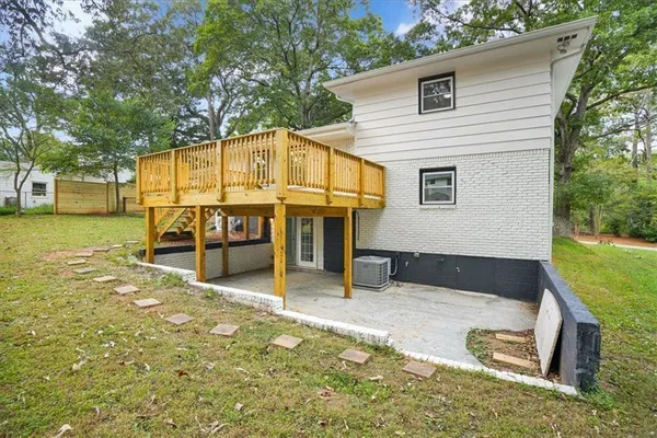 a view of a house with a yard and sitting area
