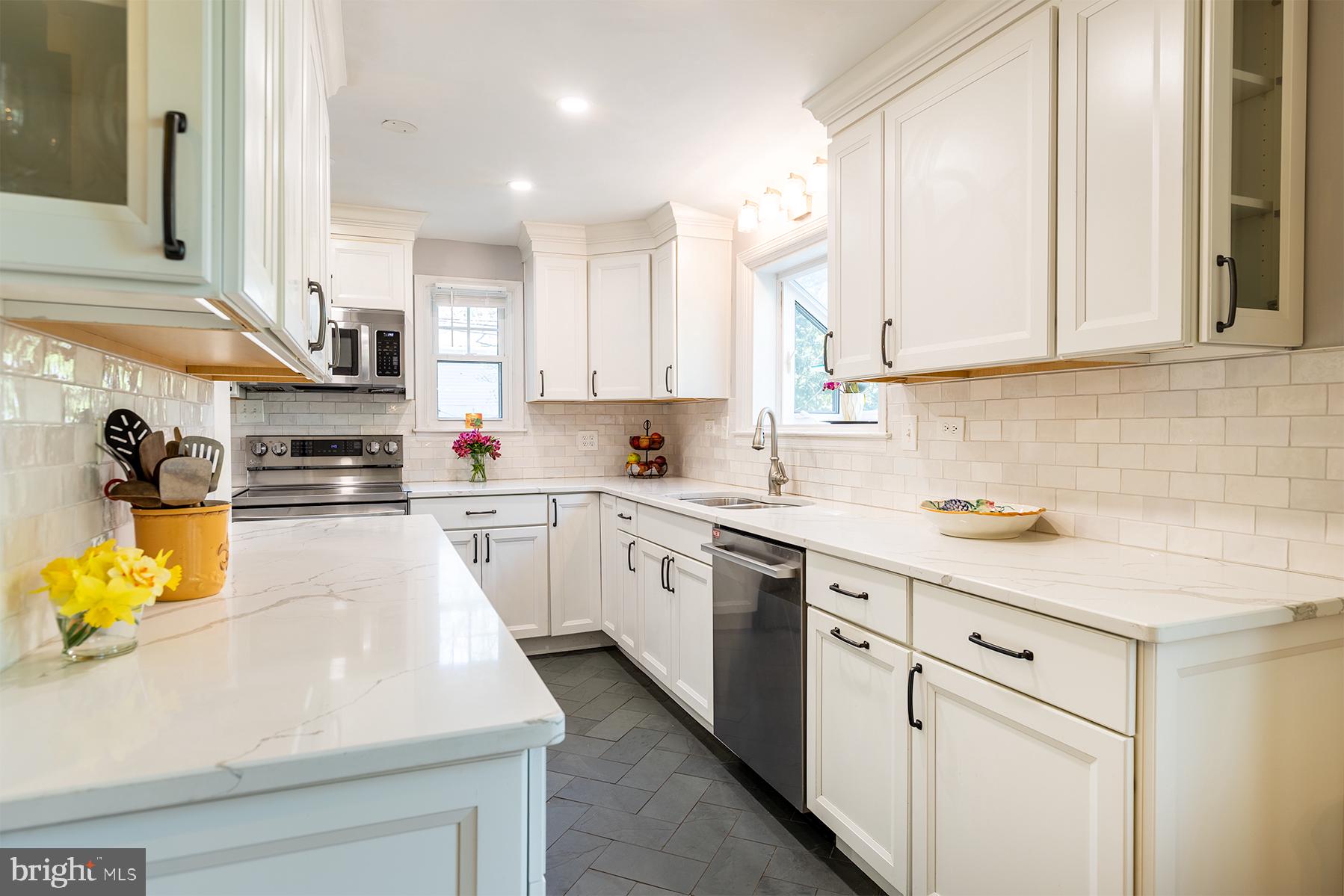 1438 Ridgeway East Arnold, MD 21012 - Photo 9 of 50 a kitchen with stainless steel appliances granite countertop a sink a stove and cabinets