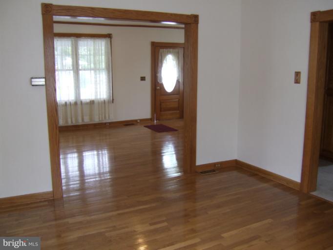 2 Hampton Road Linthicum Heights, MD 21090 - Photo 2 of 25 a view of empty room with wooden floor and fan