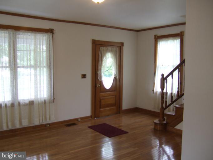2 Hampton Road Linthicum Heights, MD 21090 - Photo 16 of 25 an empty room with wooden floor mirror and windows