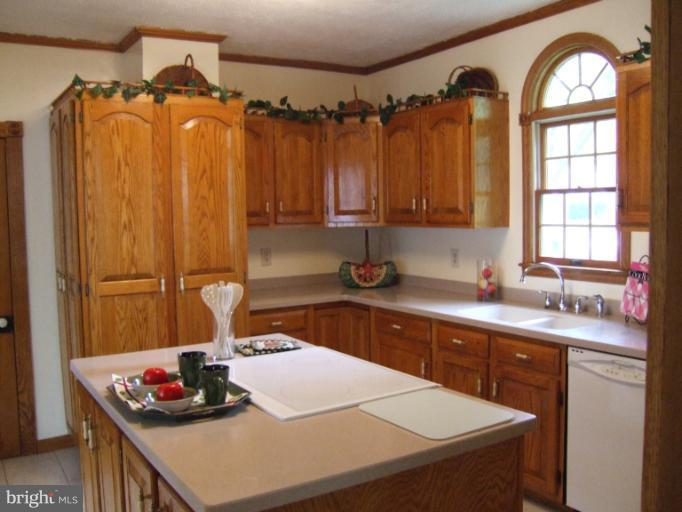 2 Hampton Road Linthicum Heights, MD 21090 - Photo 19 of 25 a kitchen with a sink a stove and a wooden cabinets