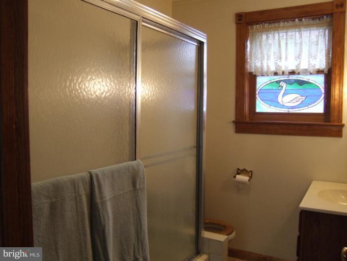 2 Hampton Road Linthicum Heights, MD 21090 - Photo 5 of 25 a bathroom with a toilet and a shower curtain