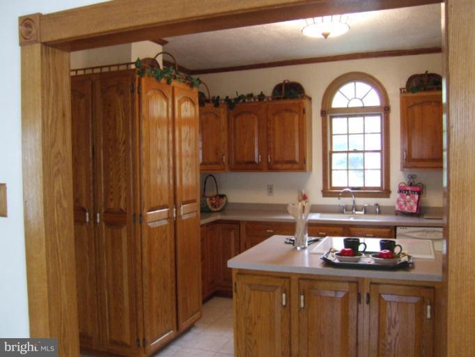 2 Hampton Road Linthicum Heights, MD 21090 - Photo 8 of 25 a kitchen with a sink a refrigerator and cabinets