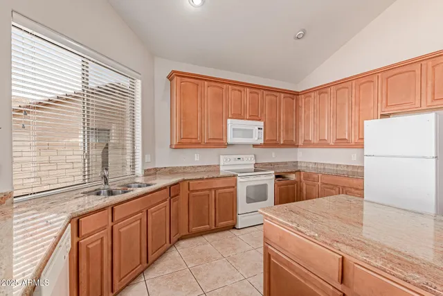 a kitchen with stainless steel appliances granite countertop a sink and a stove
