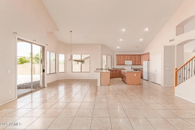a view of a kitchen with furniture and an empty room