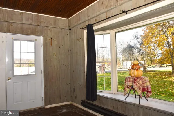 a view of a room that has a window and wooden floor