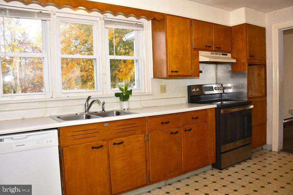 121 Country Club Lane Mill Hall, PA 17751 - Photo 19 of 31 a kitchen with stainless steel appliances granite countertop a sink stove and refrigerator